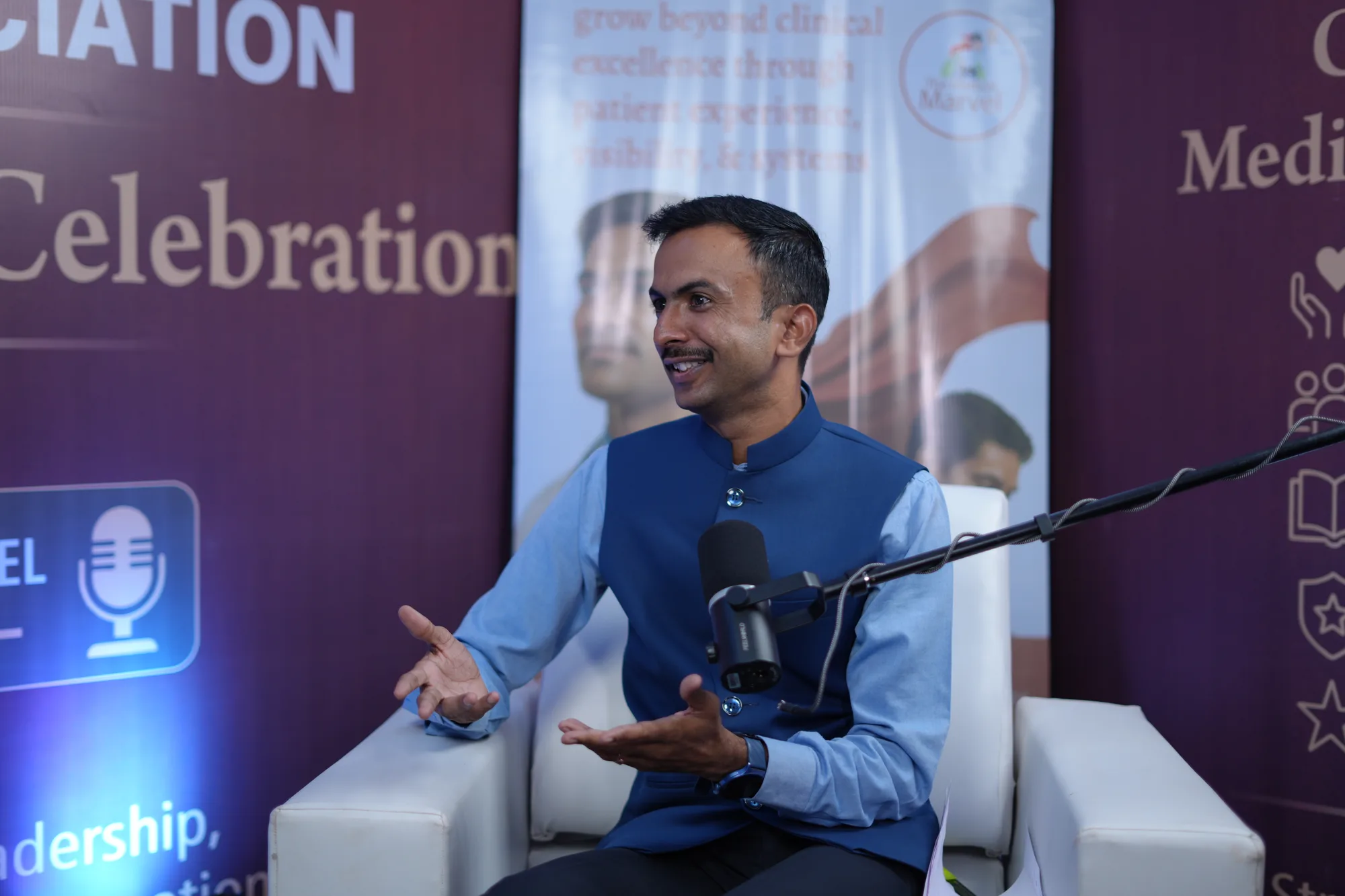 Ramesh Chandra in conversation in the podcast studio at a medical association conference.